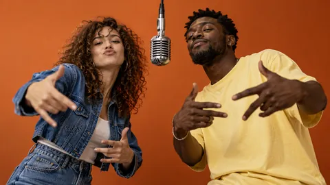 Two fictional adult friends performing at the orange-stage microphone
